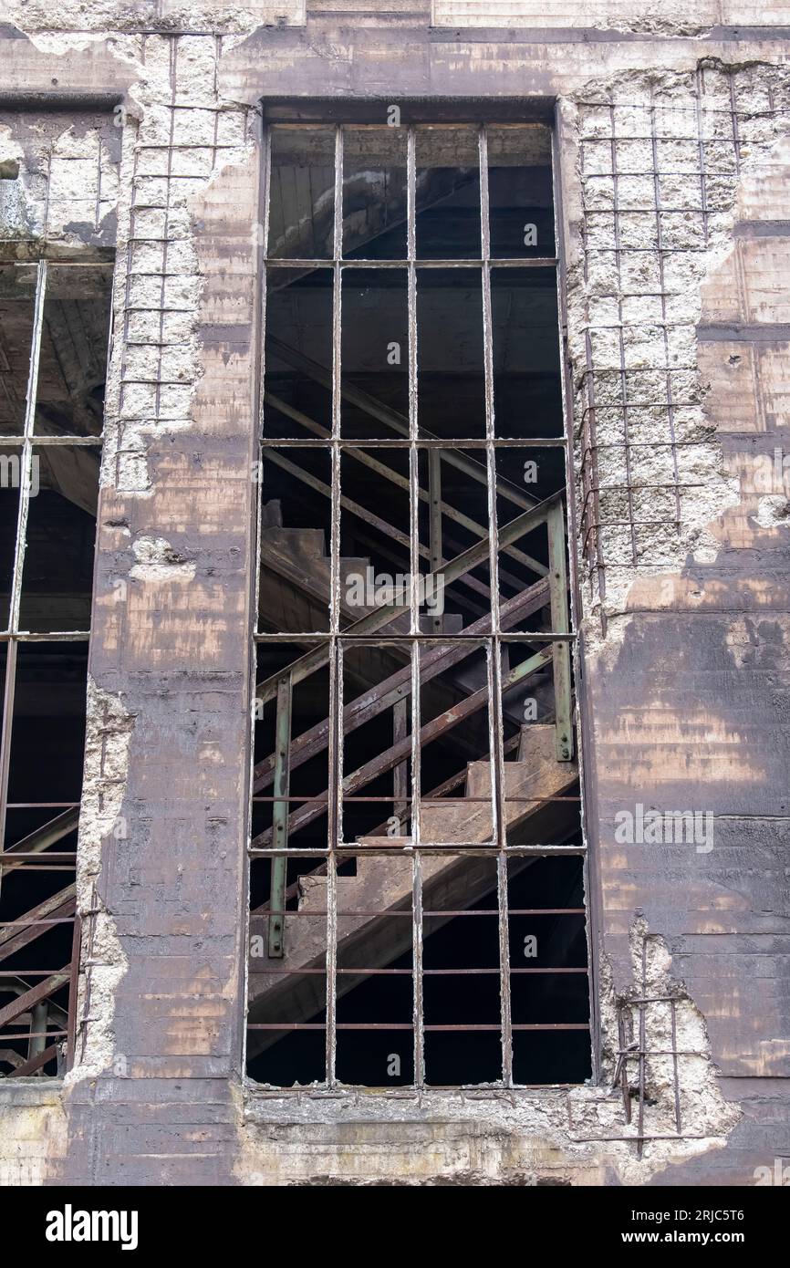 Low angle view of façade of a building in abandoned and dilapidated industrial steel mill in public Landschaftspark, Duisburg, Germany with large ungl Stock Photo