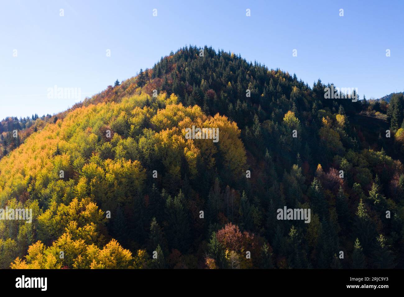 Morning haze in the mountains. Aerial drone view of autumn countryside hills in Transylvania, Romania Stock Photo