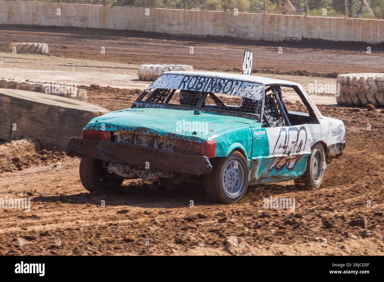 Dirt track racing with amateur stock cars. Heaps of lying mud as the ...