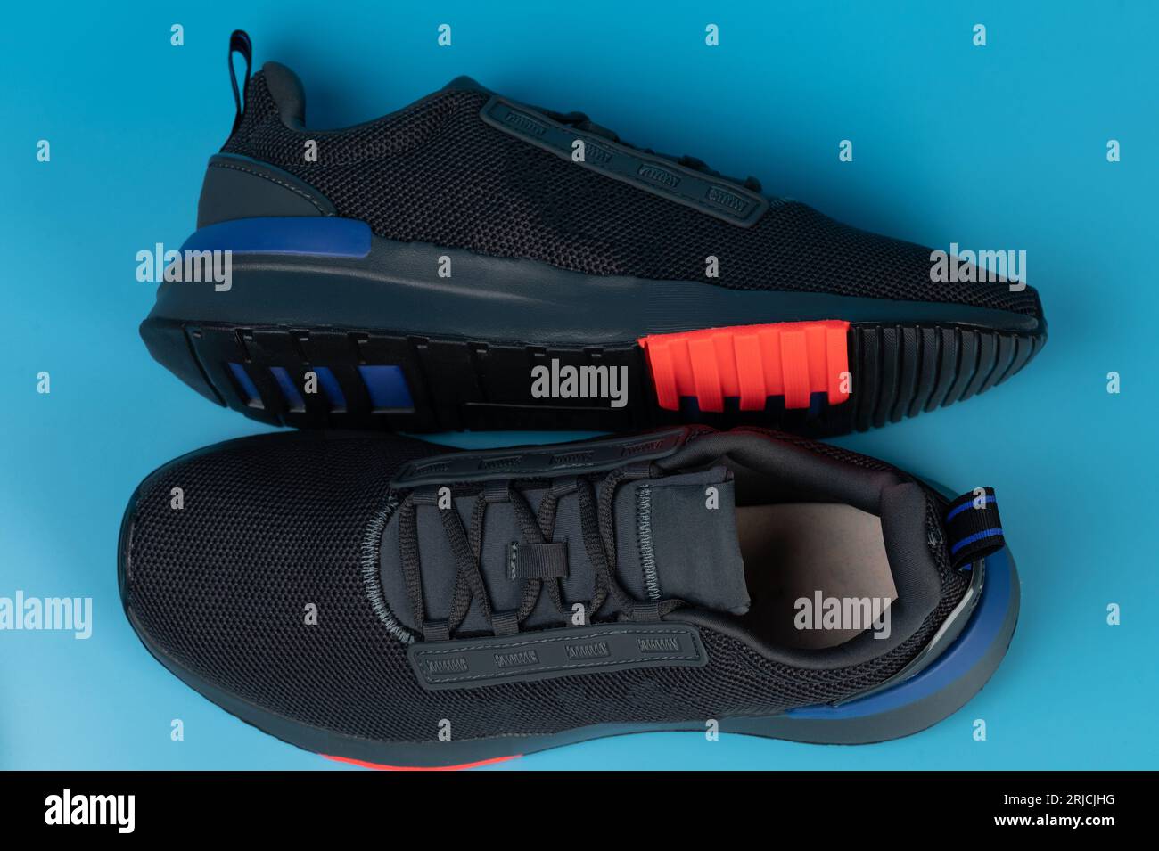 Pair athletic black shoes isolated on blue studio background Stock Photo