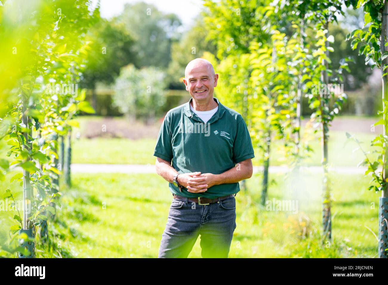 Ellerhoop, Germany. 22nd Aug, 2023. Andreas Wrede, head of nursery trials at the Chamber of Agriculture's Horticultural Center in Ellerhoop, stands among various elm varieties being researched for a nursery-suitable specimen that can be produced economically and in a climate-sensitive manner. Which trees can withstand the advancing climate change in our cities? Experts sought solutions on Tuesday at a symposium in the Ellerhoop nursery center (Pinneberg district). Credit: Jonas Walzberg/dpa/Alamy Live News Stock Photo