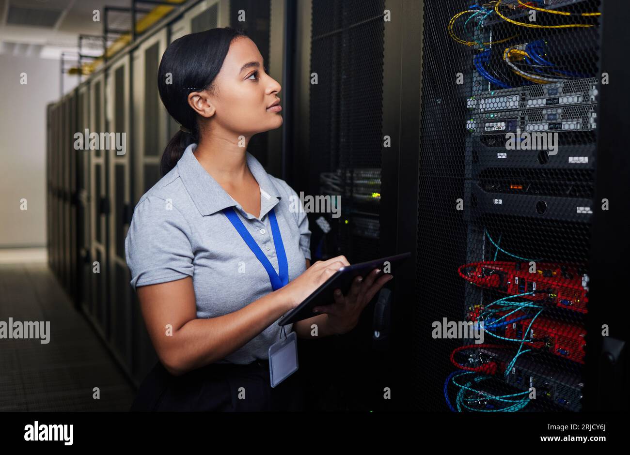 Woman, engineering tablet and server room, data center inspection or system solution for cybersecurity coding. IT person on digital technology, cables Stock Photo
