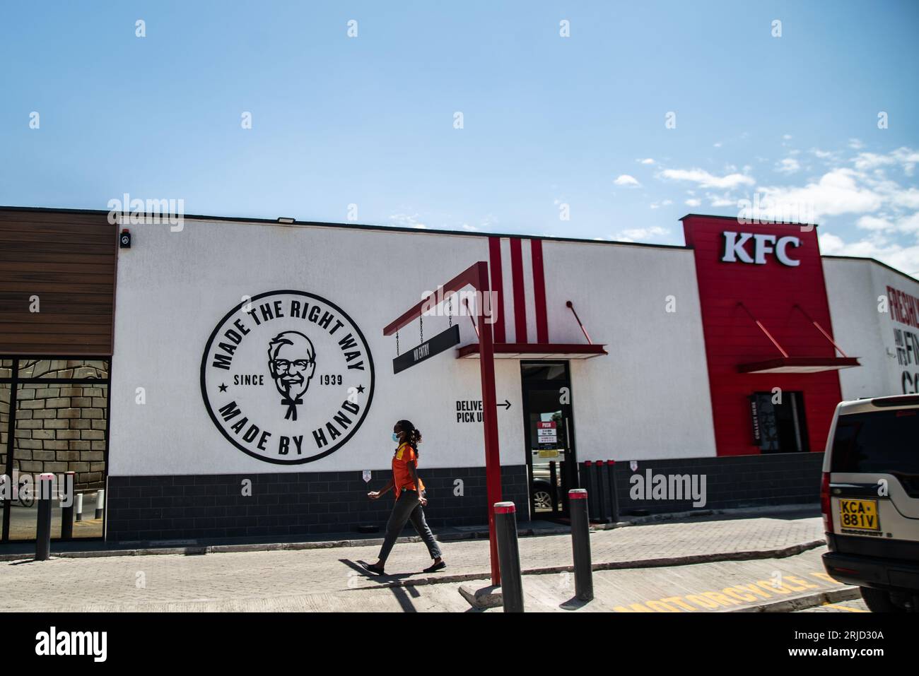 Nakuru, Kenya. 22nd Aug, 2023. A woman walks past a branch of an
