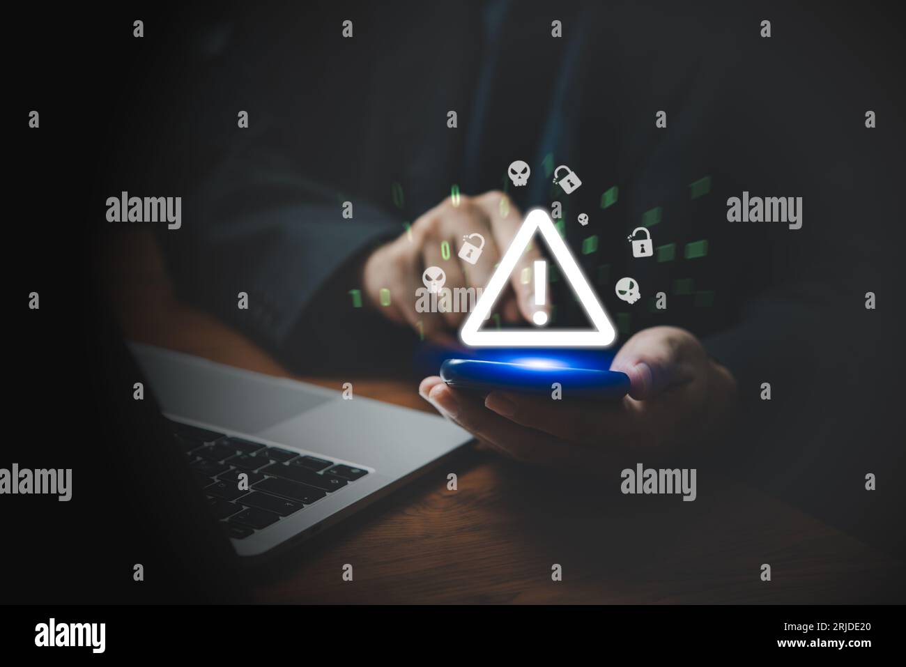 Businessman using mobile smartphone and computer laptop with triangle caution warning sing. Failure Attacked Hacked Virus Abound Concept. Problem for Stock Photo