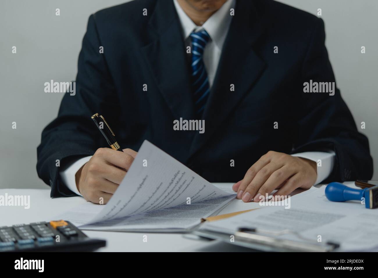 Businessperson checking and reviewing business documents financial reports, accounting sheets, and investment portfolios. paperwork lawyer contract. Stock Photo