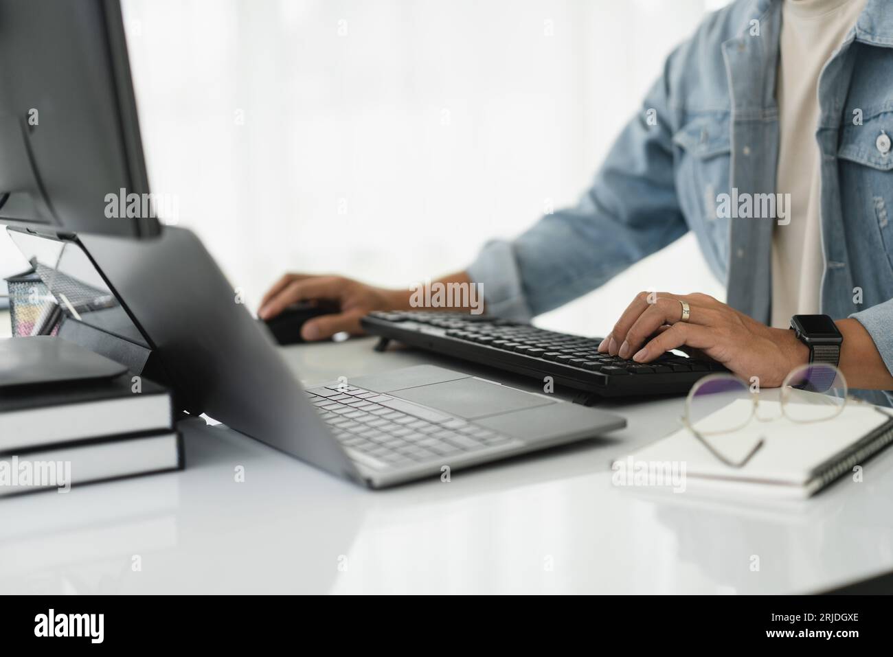 Developer programmer checking code on multiple monitor while programming to developing web and apps. Stock Photo