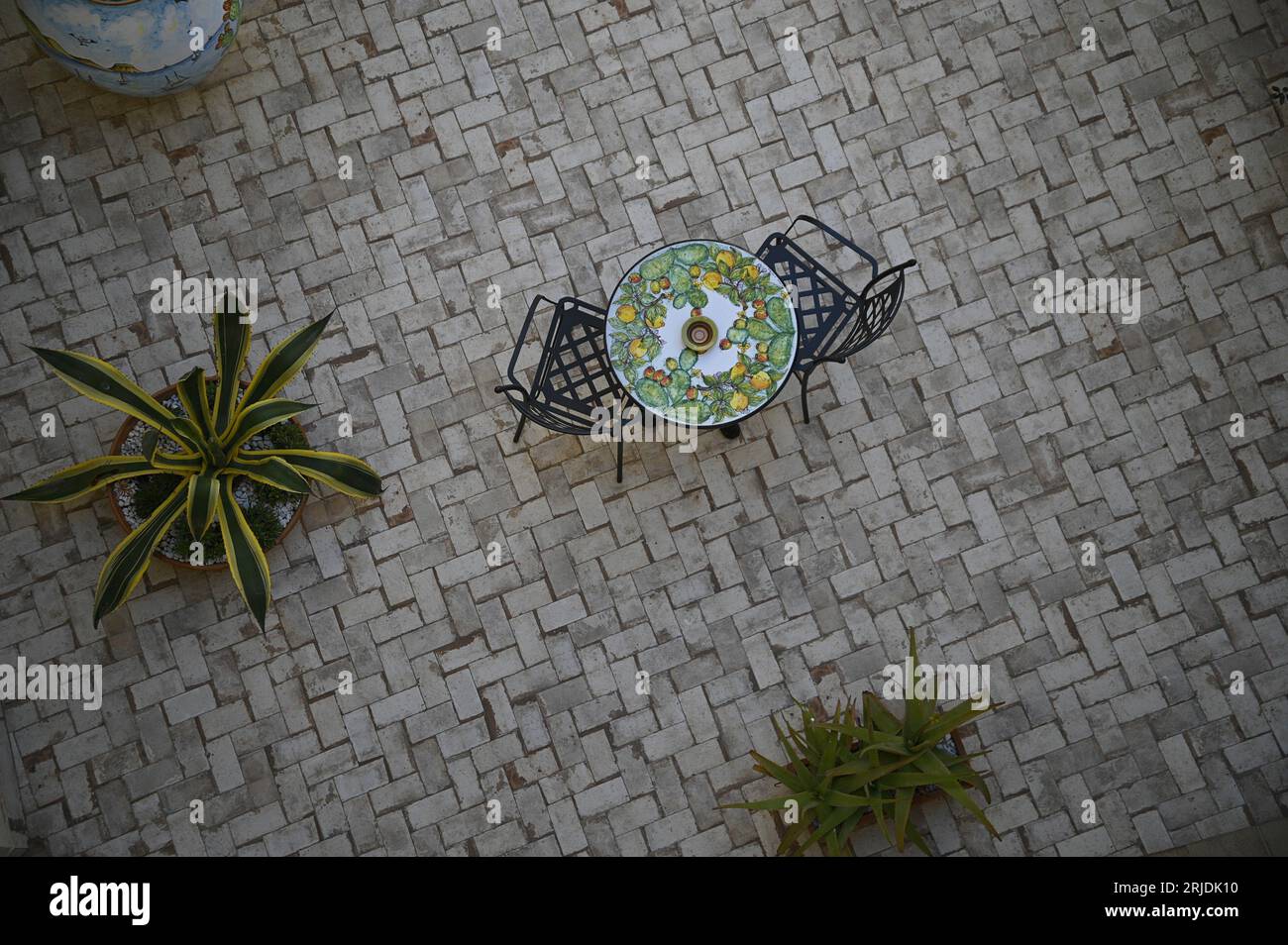 Lava stone table top with Sicilian Caltagirone lemons and cactus motifs in Sciacca Sicily, Italy. Stock Photo