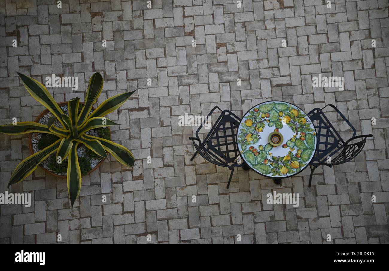 Lava stone table top with Sicilian Caltagirone lemons and cactus motifs in Sciacca Sicily, Italy. Stock Photo