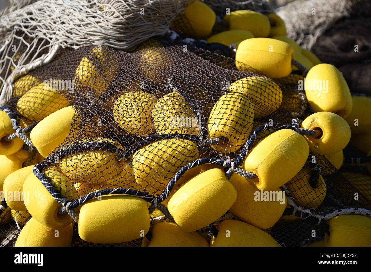 Traditional fishing nets with yellow floaters at the port of Sciacca in  Sicily, Italy Stock Photo - Alamy