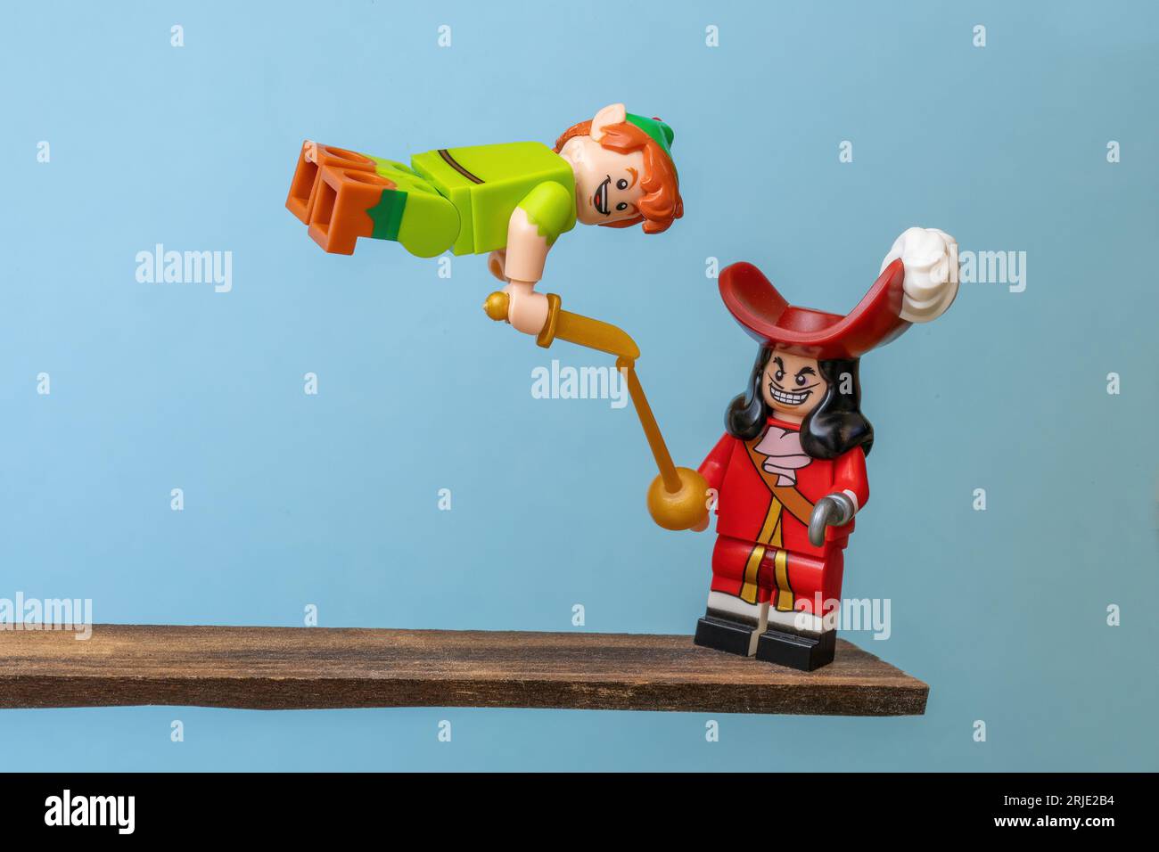 A closeup of two Lego figures, a pirate and Peter Pan, in a fight