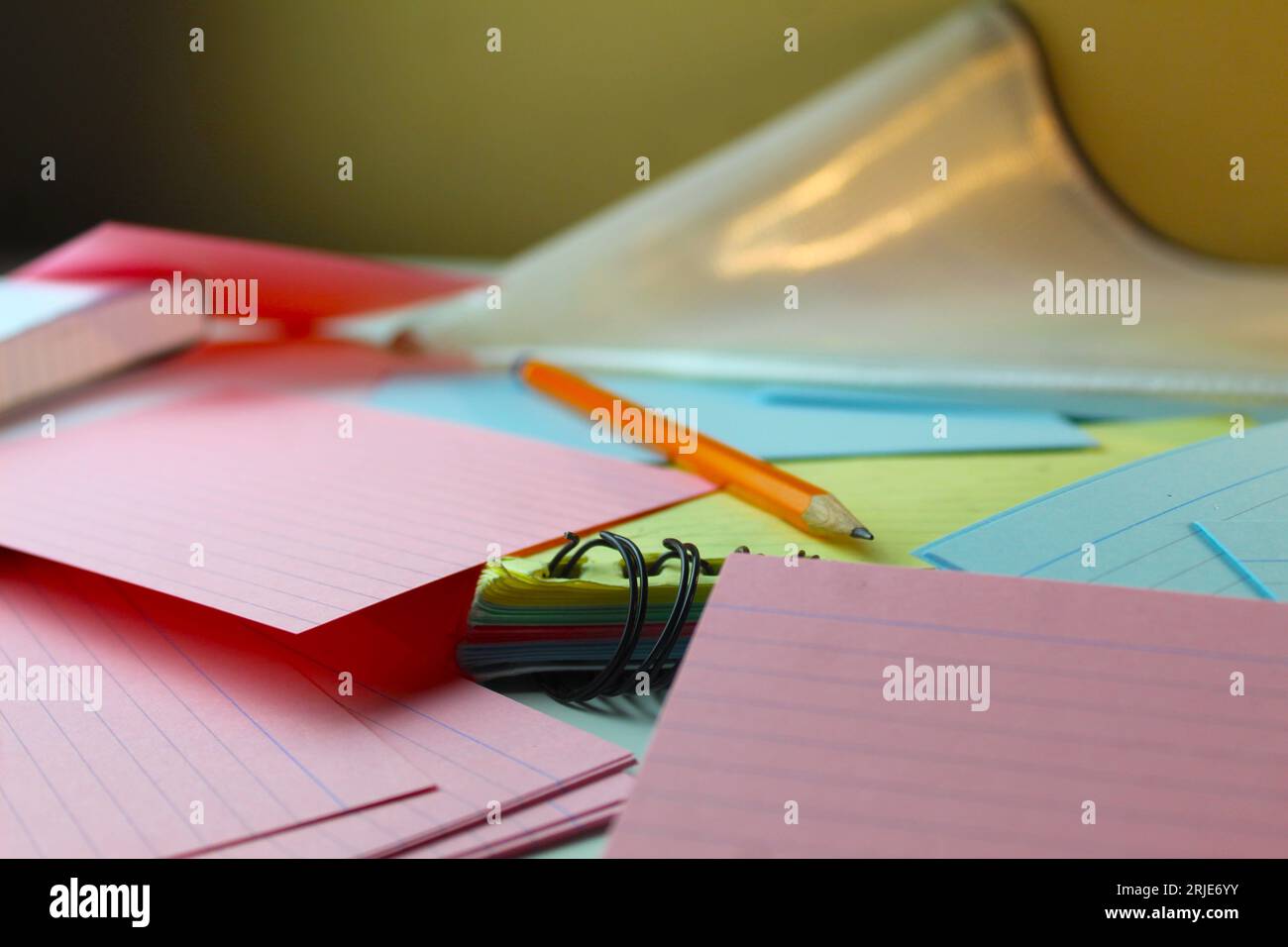 A close up photo of a school student's pencil on an array of colourful