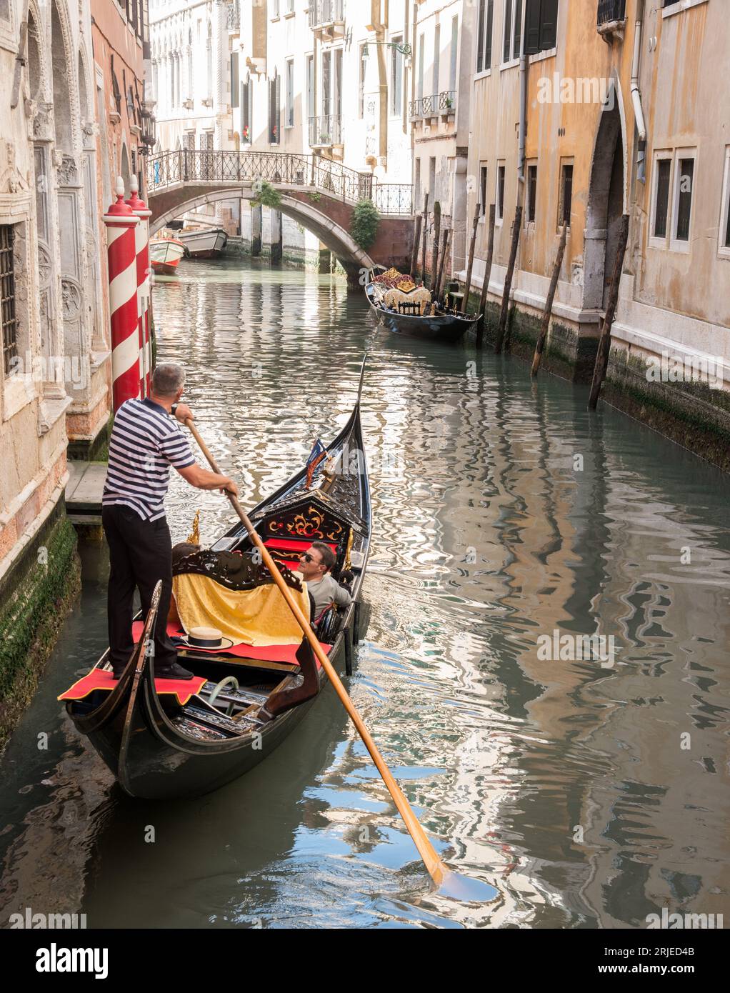 Gondola in a small canal in Venice, Italy Stock Photo