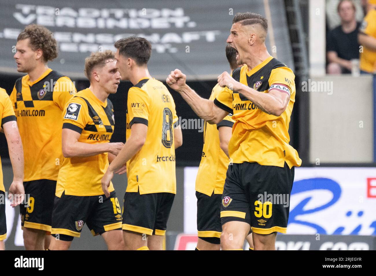 Dresden, Germany. 23rd July, 2022. Soccer: 3rd league, SG Dynamo Dresden - TSV  1860 Munich, Matchday 1, Rudolf Harbig Stadium. Dynamo's Kevin Ehlers  (l-r), Tim Knipping and Dennis Borkowski emotional. Credit: Robert