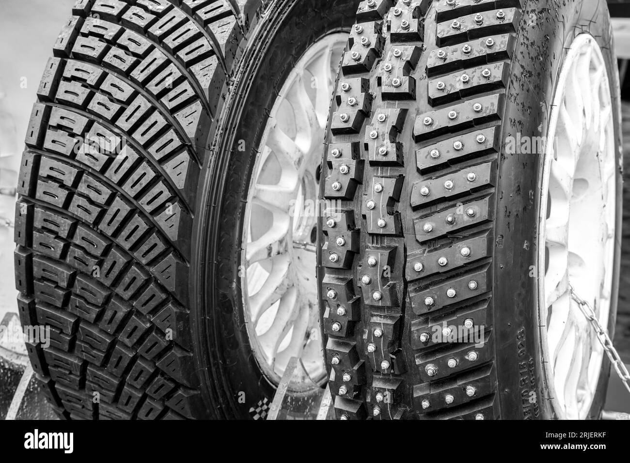 Two types of modern rally tires, studded winter snow and ice tire with