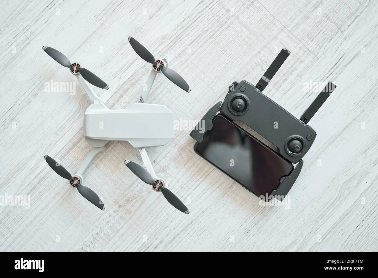 Top view of modern unmanned drone and remote control panel placed on