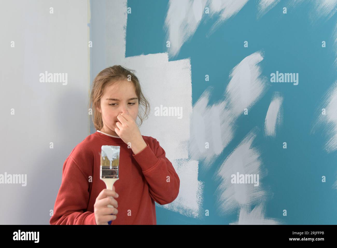 The girl covers her nose and winces at the smell of the stench of