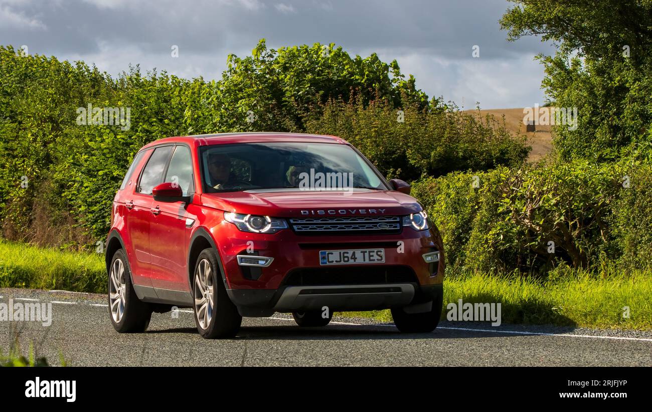 Woburn,Beds.UK - August 19th 2023: 2016 red Land Rover Discovery Sport  car travelling on an English country road. Stock Photo