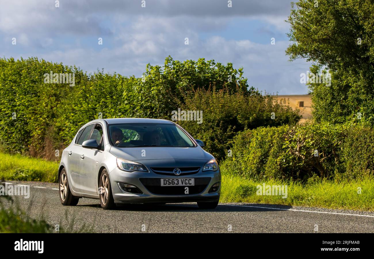 Woburn,Beds.UK - August 19th 2023: 2013 silver Vauxhall Astra  car travelling on an English country road. Stock Photo