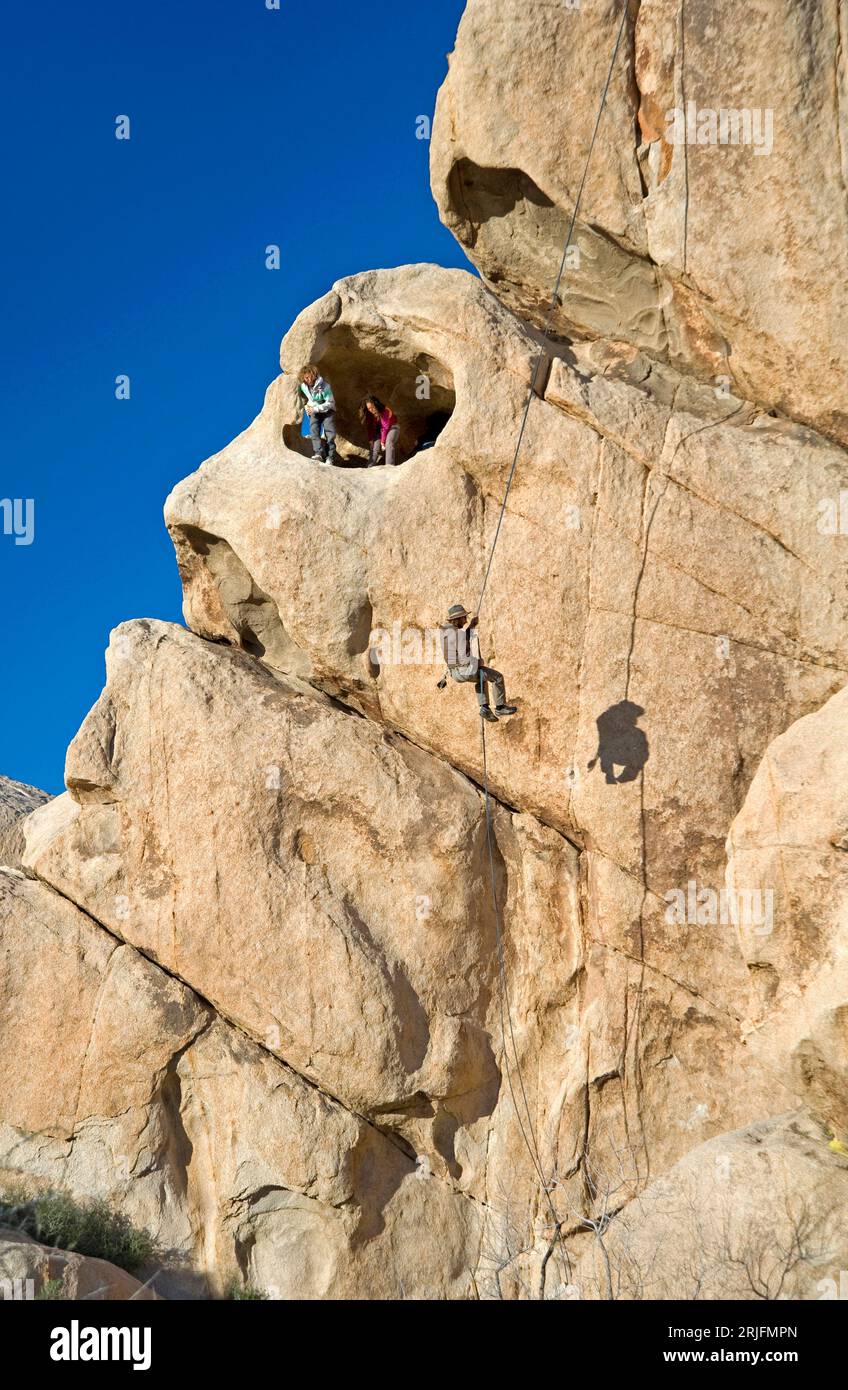 Rock climbers at Joshua Tree National Monument in California, USA Stock Photo