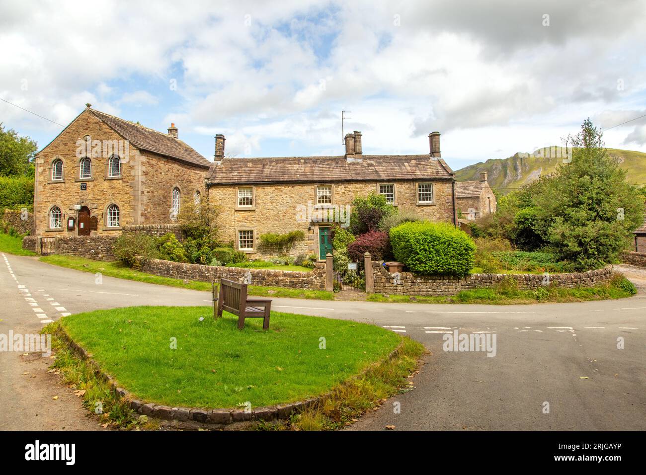 View of the old Methodist chapel and village green with a bench in the