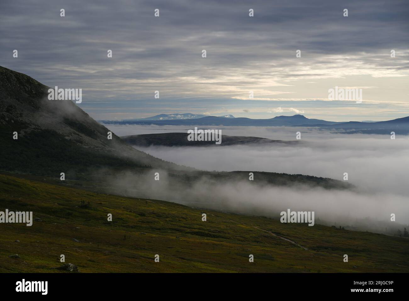 Low clouds over the forests and mountain peaks, early morning sunrise in Idre Sweden Northern Europe Stock Photo