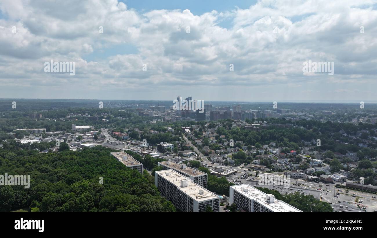 A bustling cityscape in White Plains, New York, featuring tall modern skyscrapers, roads, and residential buildings Stock Photo