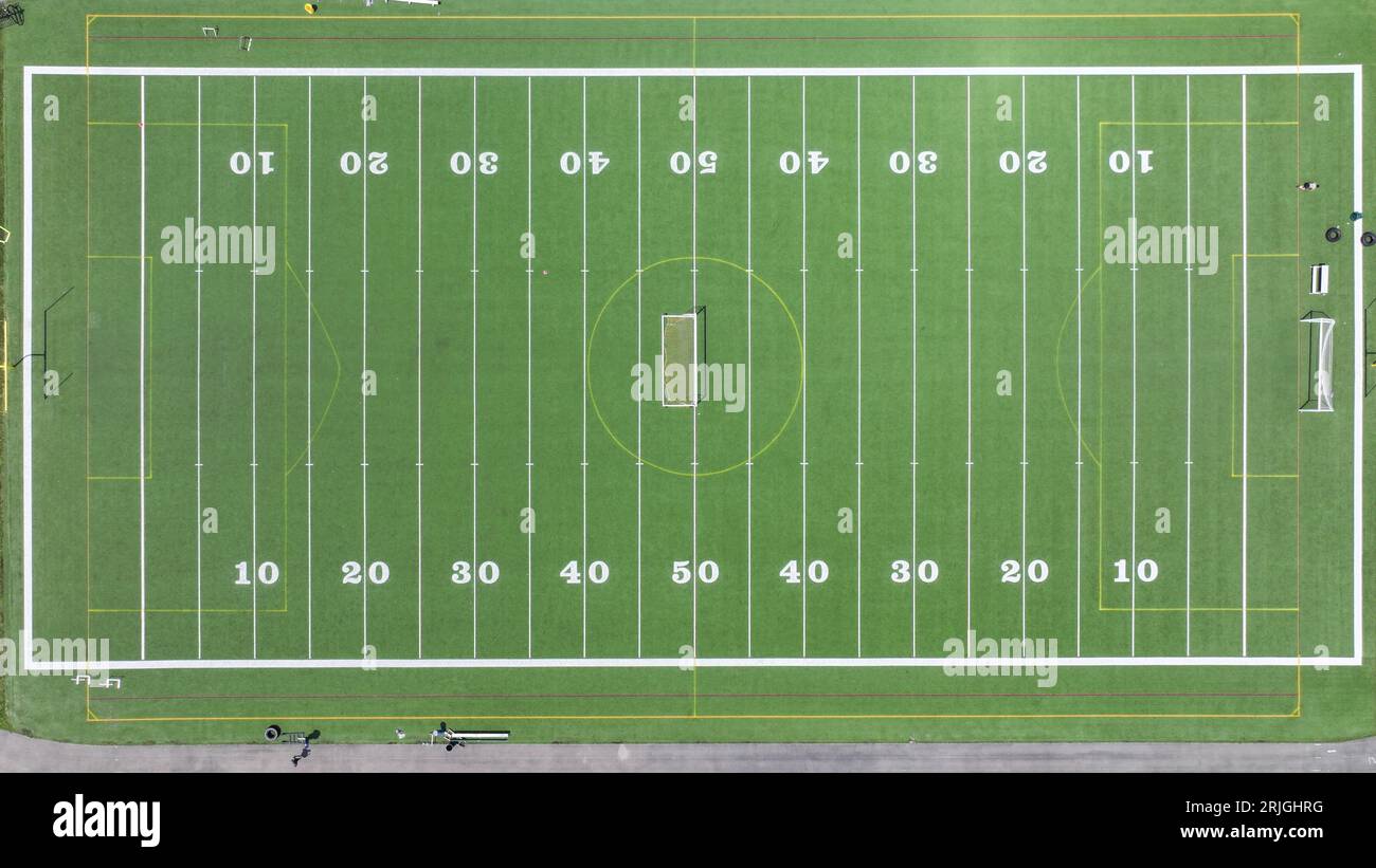 An aerial view of a soccer field with bright green grass and white ...