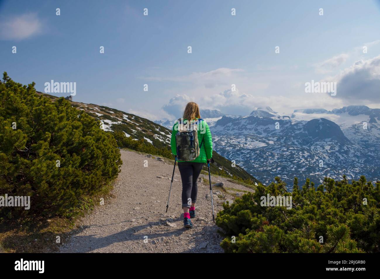 Tourist woman trekking on Mount Krippenstein in the Dachstein Mountains of Upper Austria, Salzkammergut region, Austria. Stock Photo
