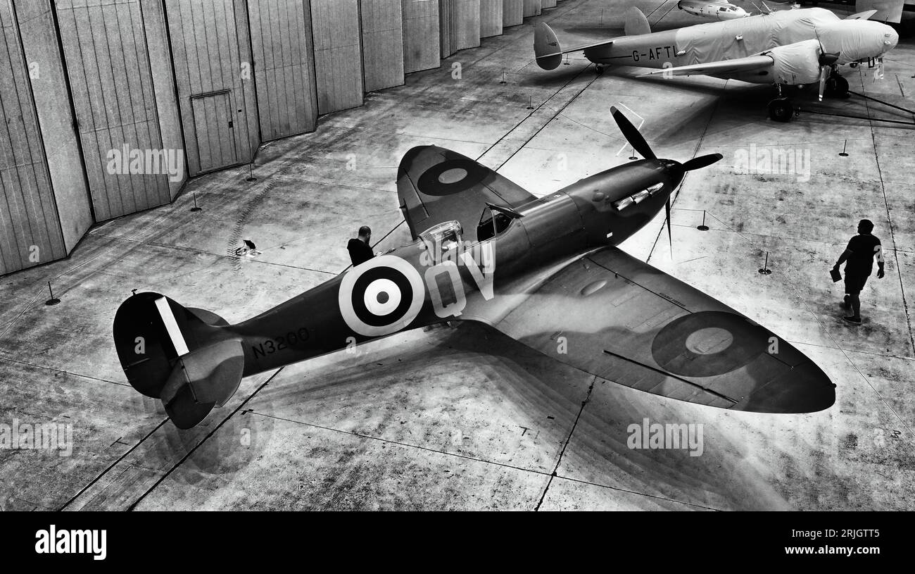 An early Supermarine Spitfire and a 1936 Lockheed 12A at the  Imperial War Museum and airfield Duxford Stock Photo