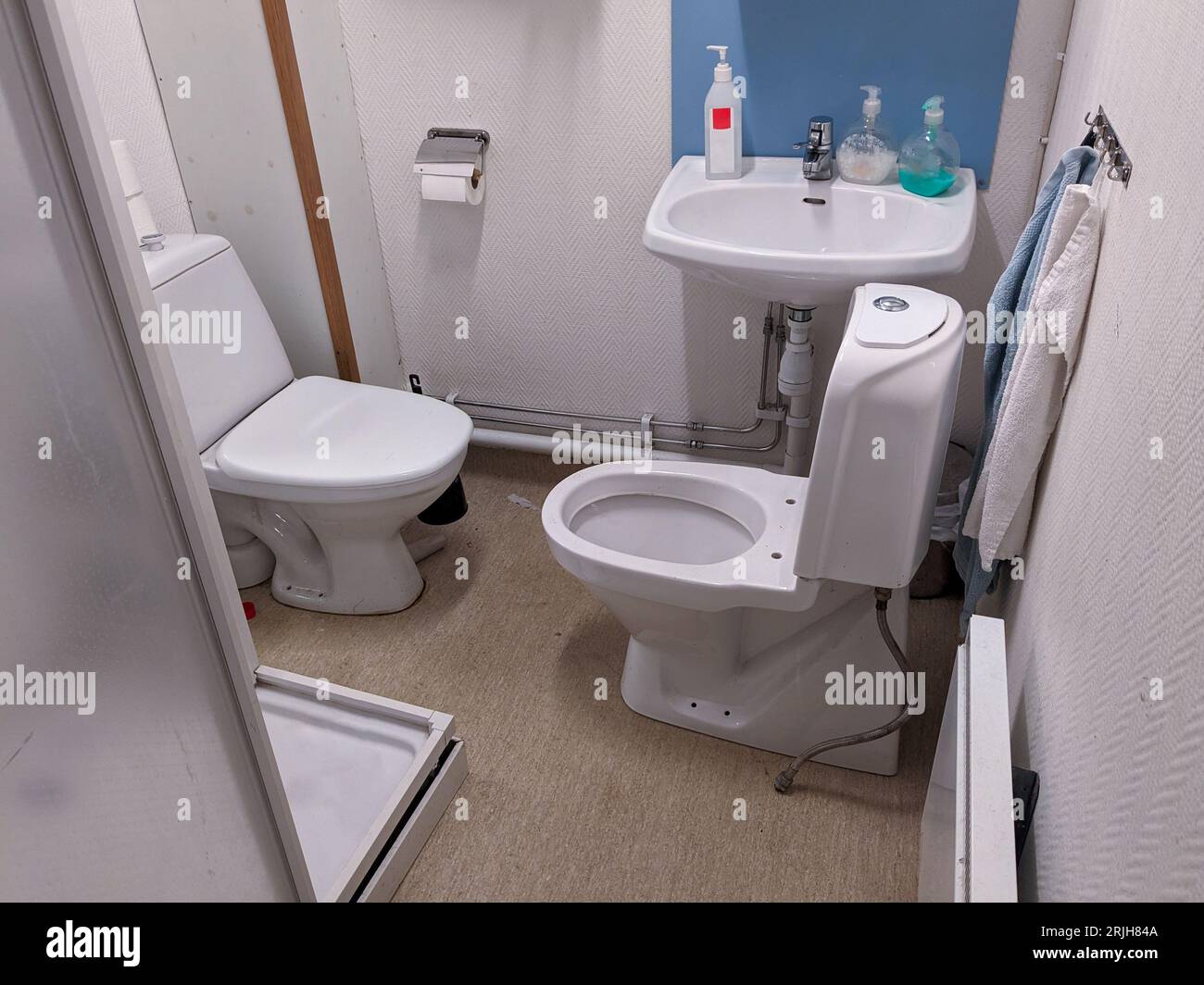 two toilets inside a restroom Stock Photo Alamy