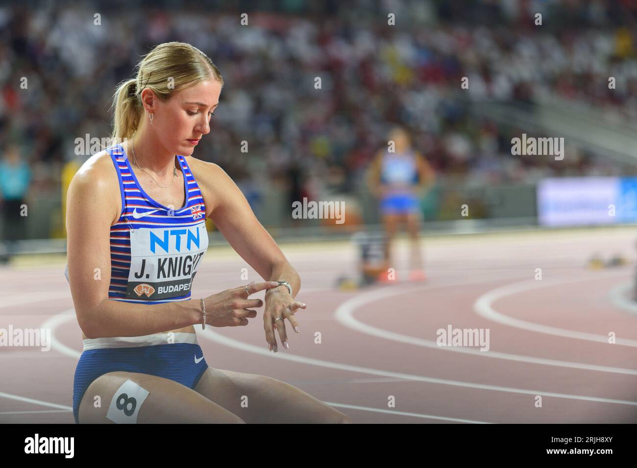 Jessie Knight (Great Britain and Northern Ireland) checking her watch before the 400 metres hurdles semi-final during the world athletics championships 2023 at the National Athletics Centre, in Budapest, Hungary