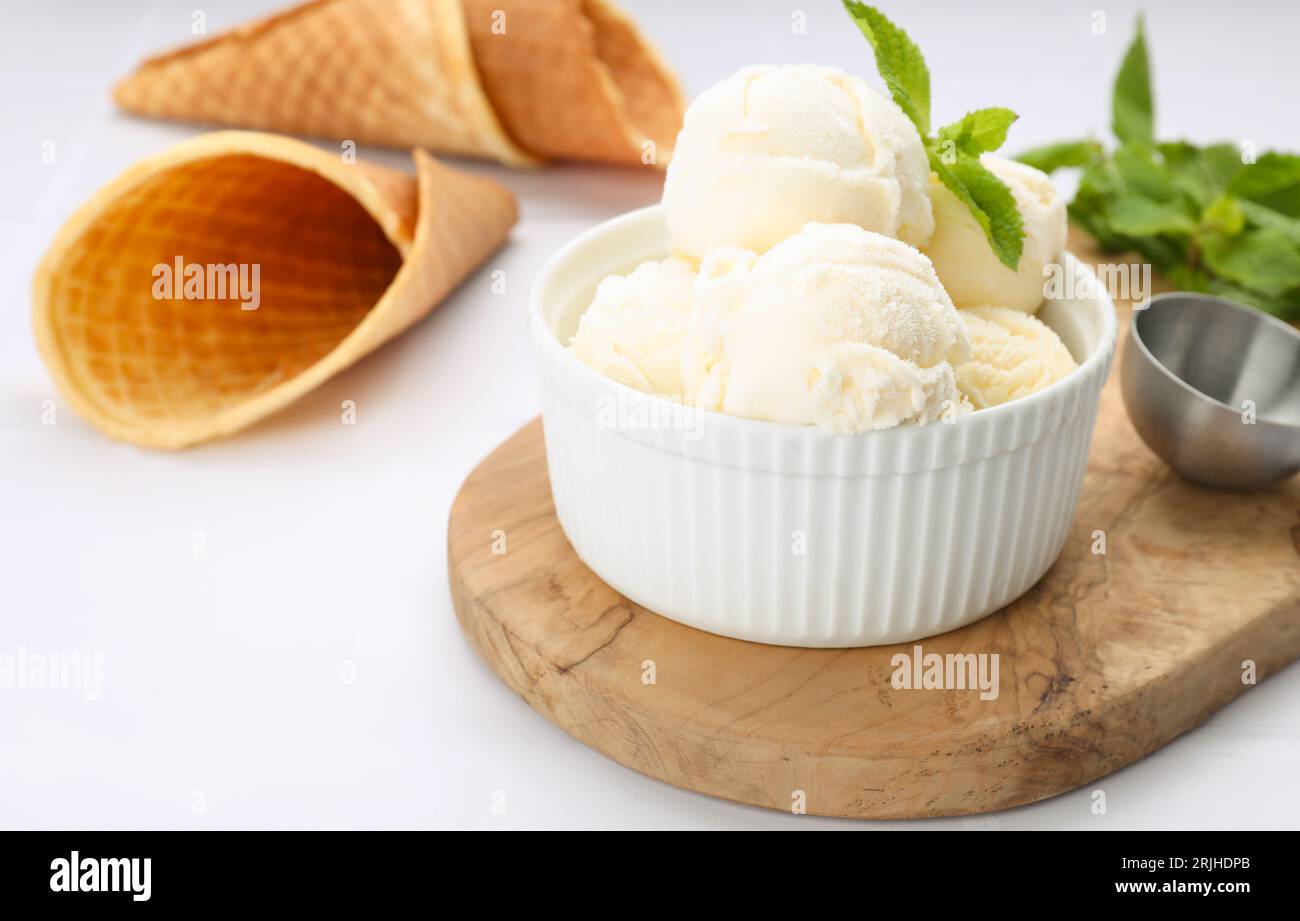 Bowl of ice cream and mint leaves on white table Stock Photo - Alamy