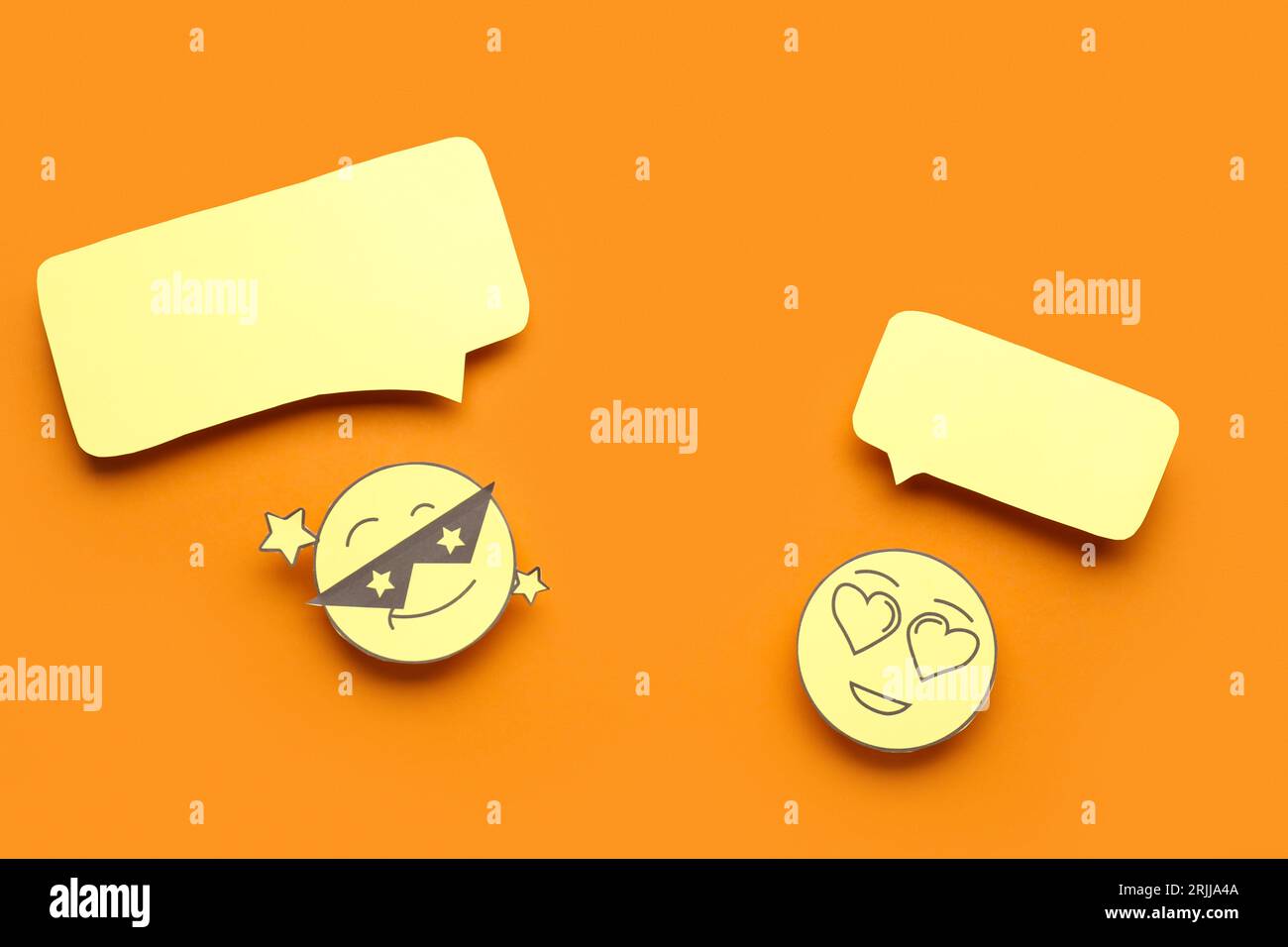 Paper faces with blank speech bubbles on orange background Stock Photo