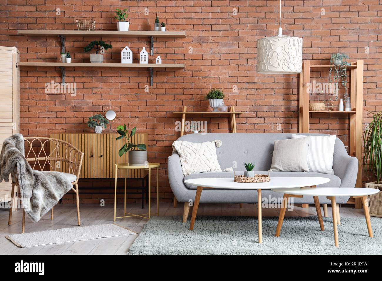 Interior of living room with armchair, sofa and houseplants Stock Photo ...