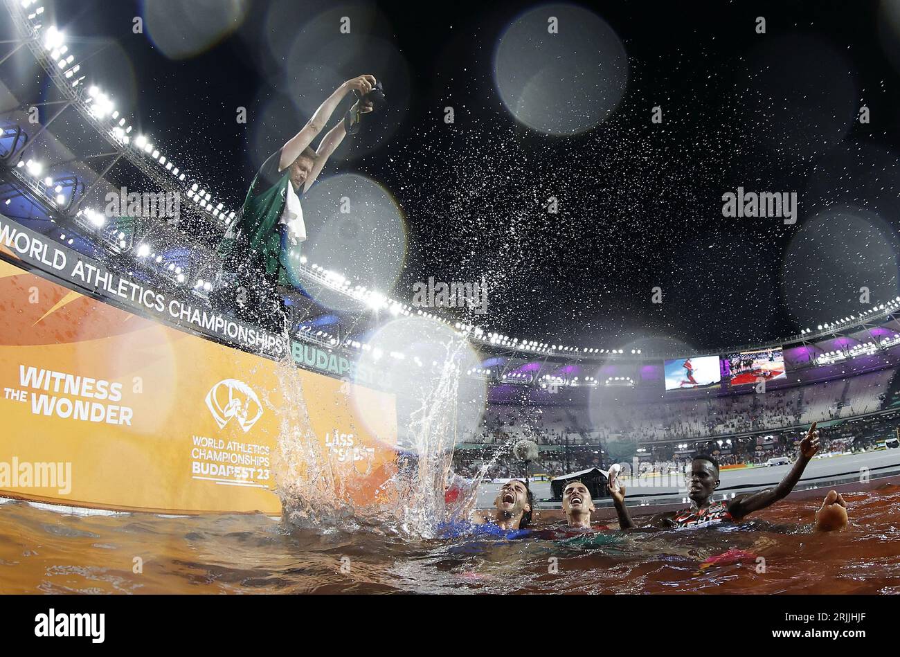 Budapest, Hungary. 22nd Aug, 2023. A photographer takes pictures for Men's high jump gold medalist Italy's Gianmarco Tamberi (2nd L), Men's 3000m Steeplechase gold medalist Soufiane El Bakkali (2nd R) of Morocco and bronze medalist Abraham Kibiwot of Kenya (1st R) at the World Athletics Championships Budapest 2023 in Budapest, Hungary, Aug. 22, 2023. Credit: Wang Lili/Xinhua/Alamy Live News Stock Photo