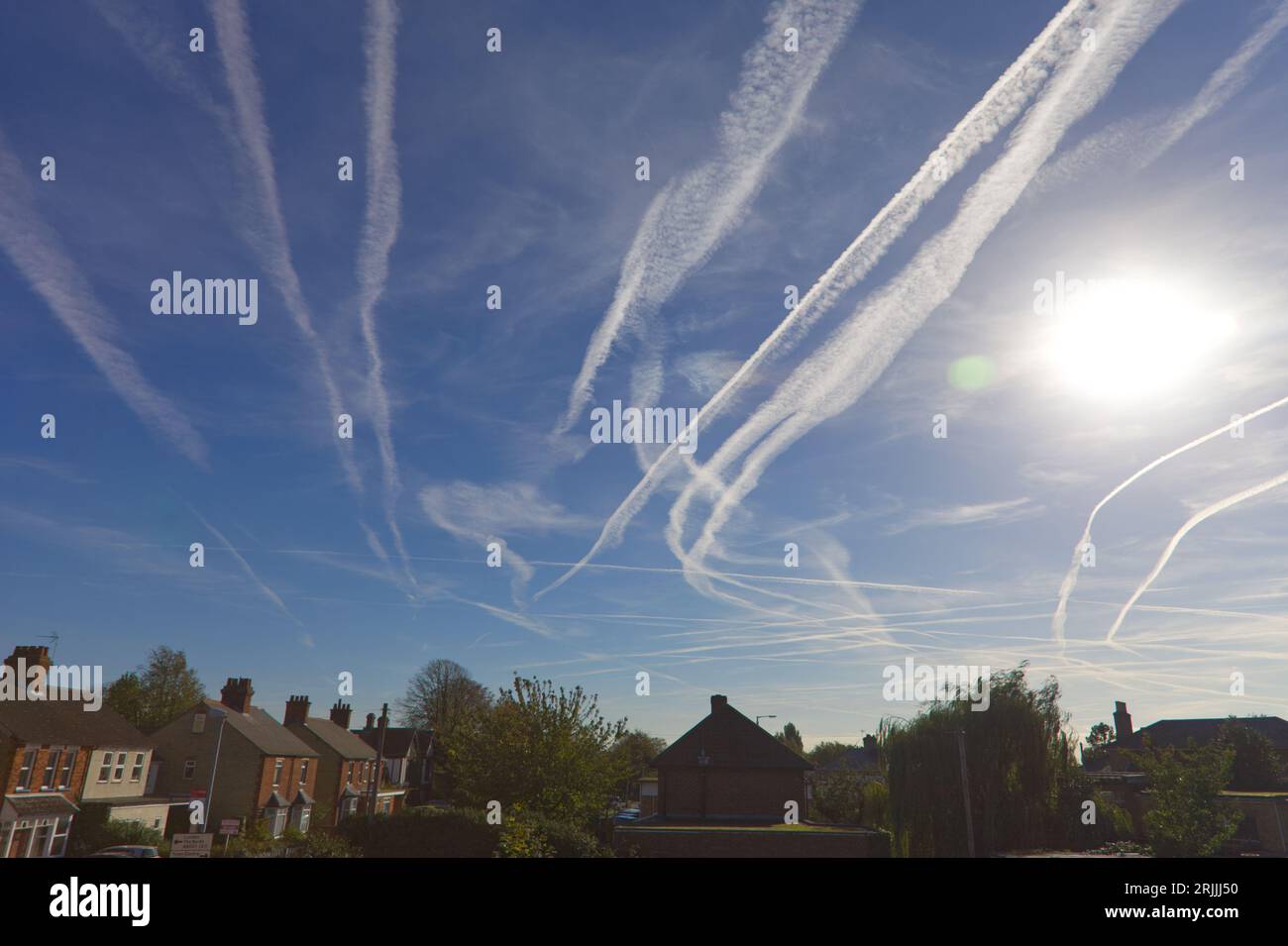 Global warming plane vapour trials over England Stock Photo
