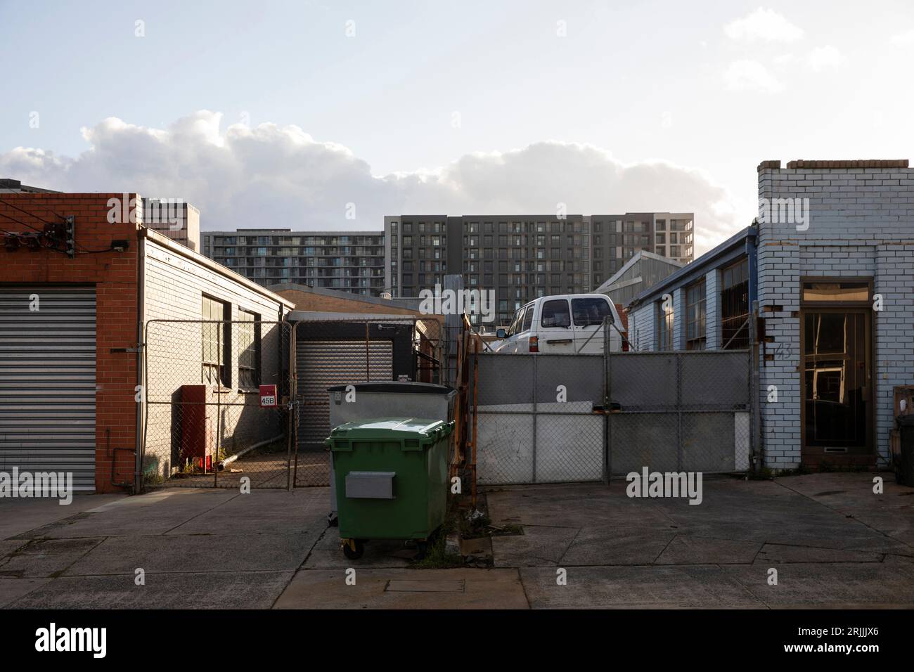 View of Old industrial workshops below new apartment buildings, showcasing the ...