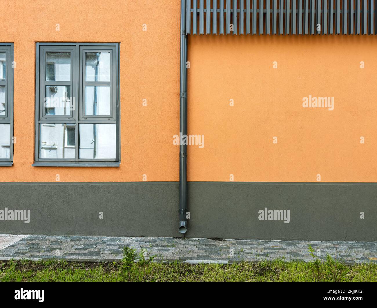 old industrial building after renovation. windows on orange stucco wall. Stock Photo