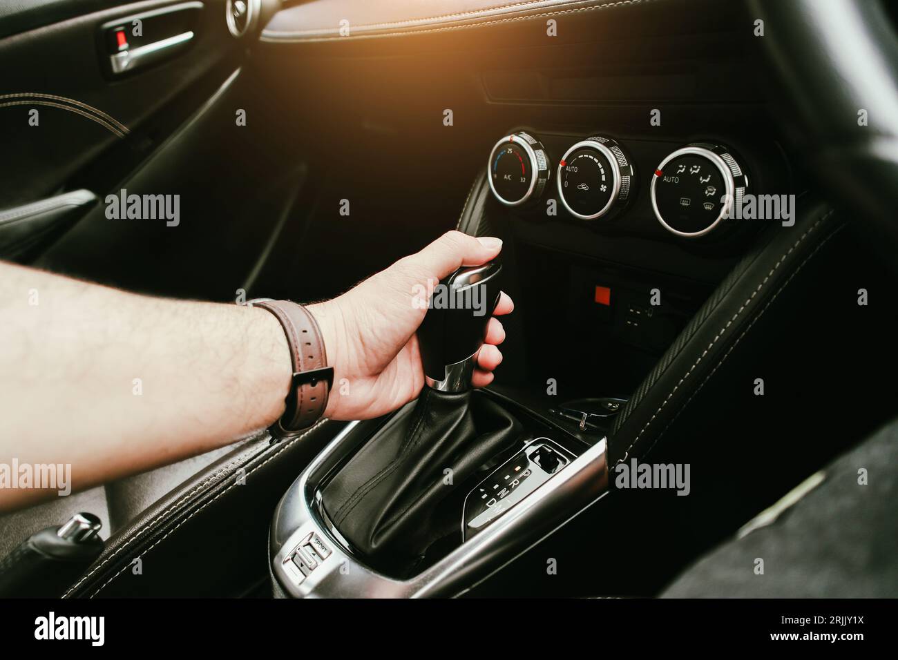 Driver hand holding gear lever of automatic transmission and hand moves