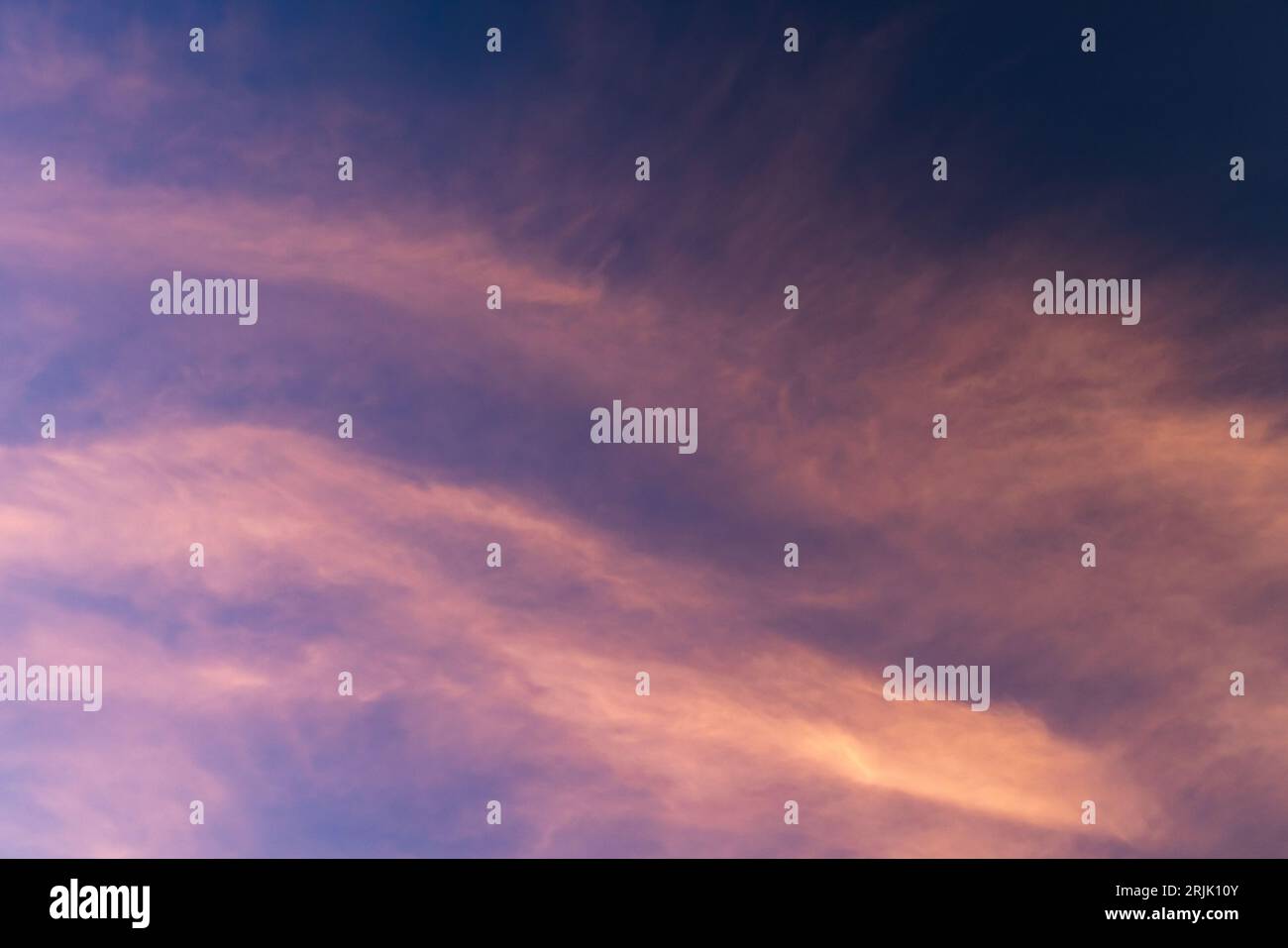 Colorful sky with pink cirrus clouds at sunset, natural background photo texture Stock Photo