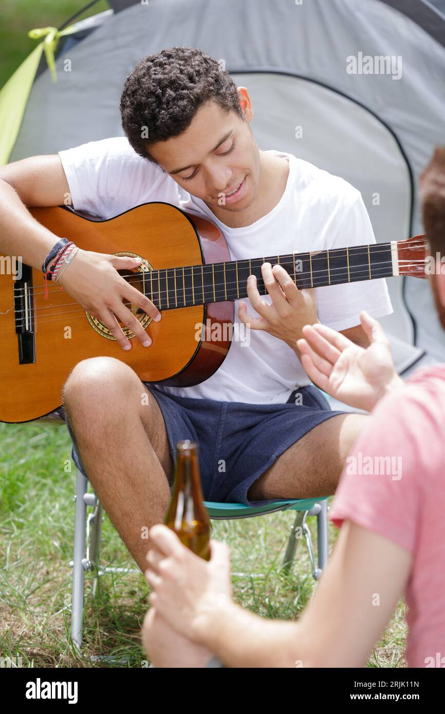 pensive man playing guitar forest Stock Photo