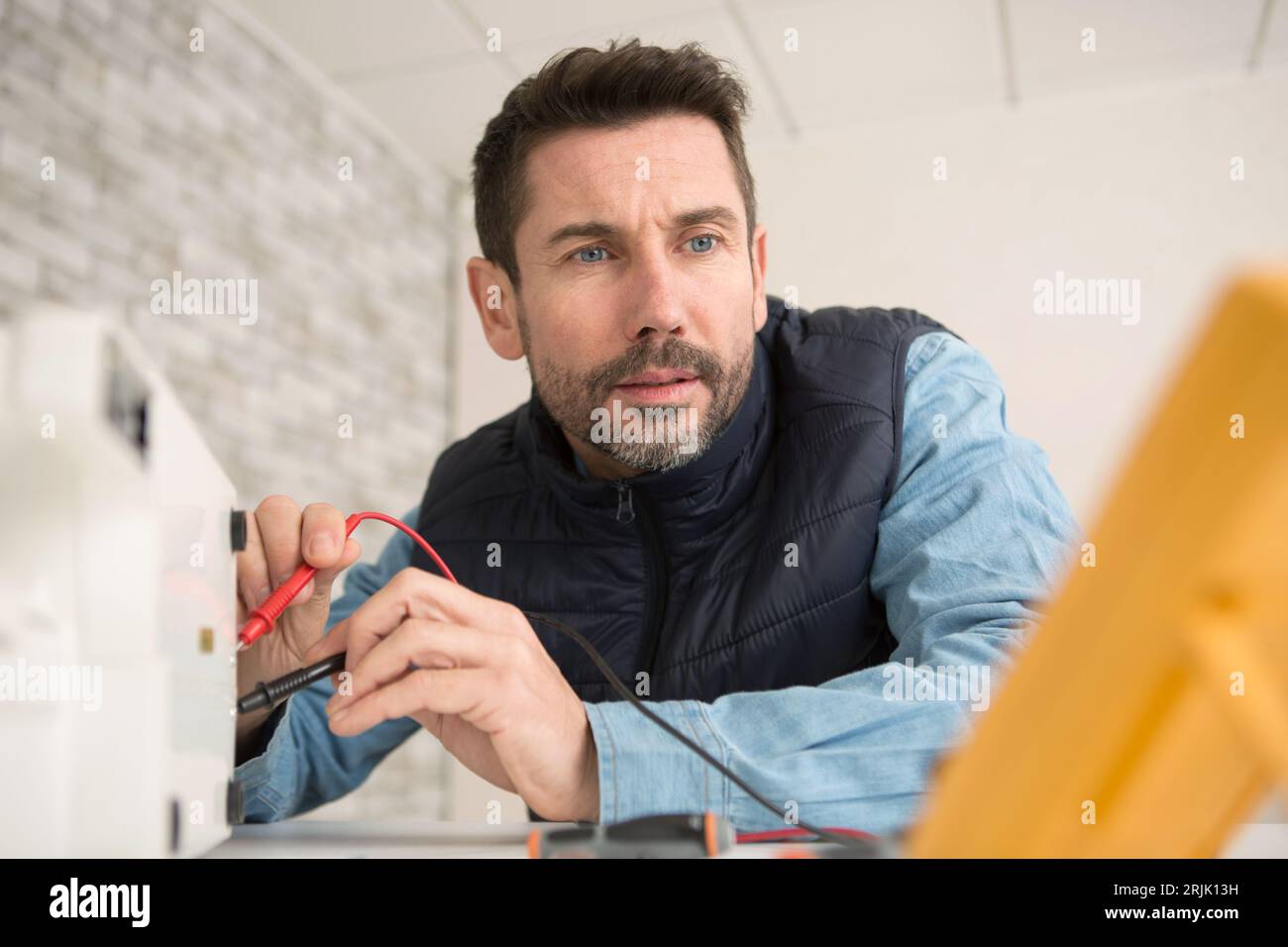 electrician measuring voltage of cable Stock Photo Alamy