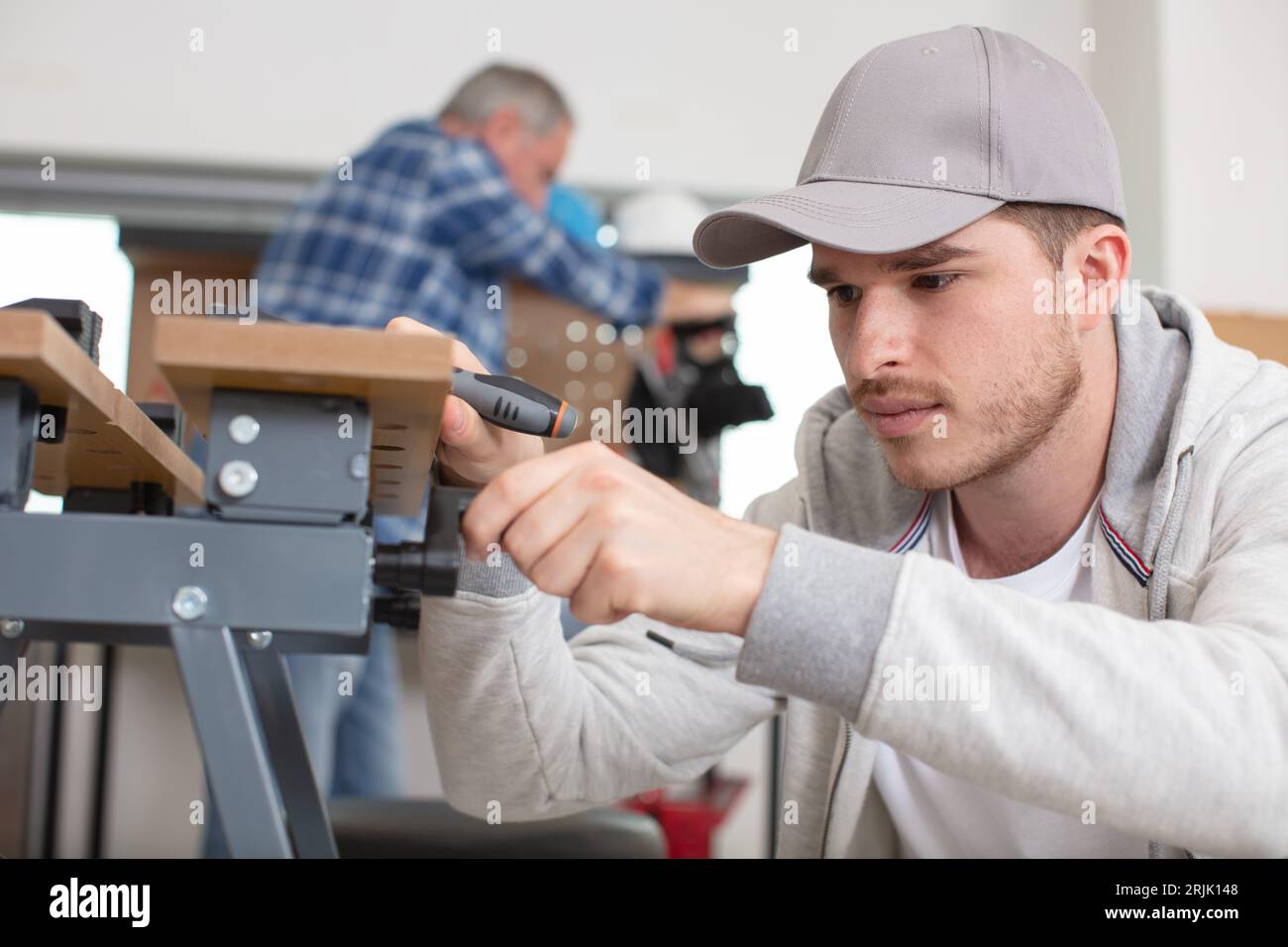 carpenter with apprentice in training period Stock Photo
