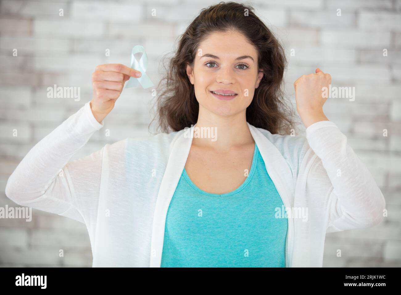 female holding green organ transplant awareness ribbon Stock Photo - Alamy