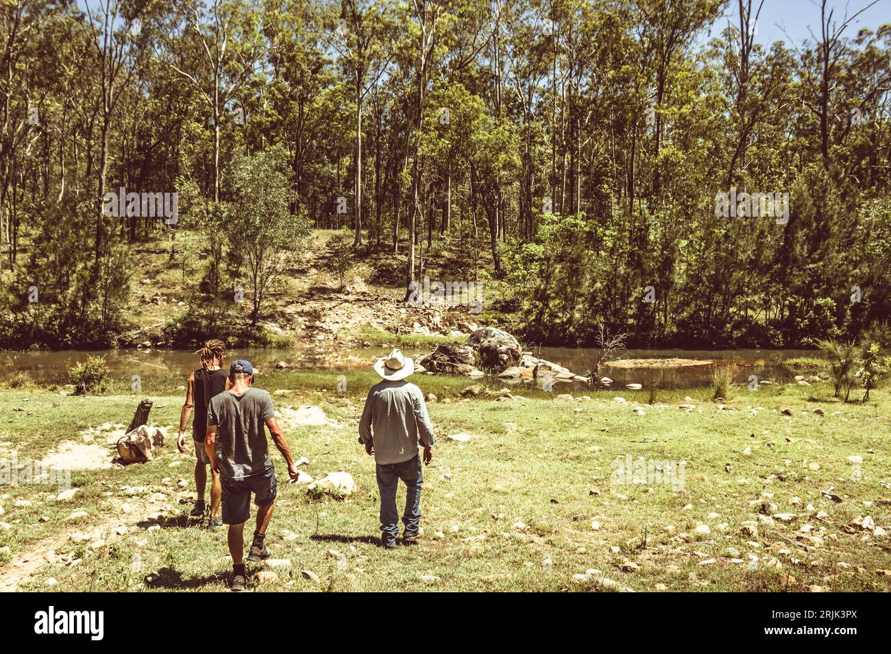 A scene of country exploration with rural hikers trailing through river