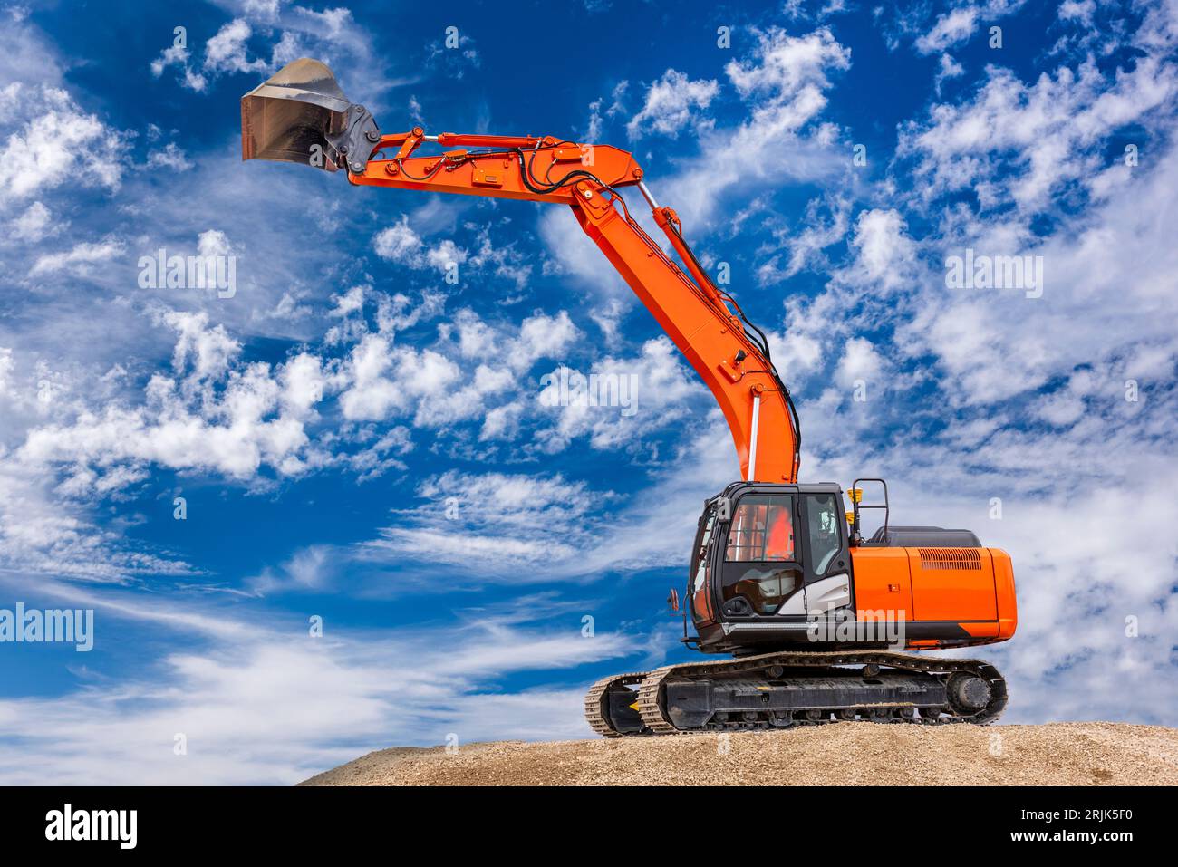 excavator is in work and digging at construction site Stock Photo