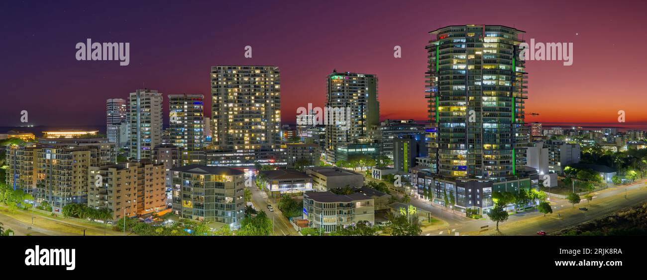 Panorama of Darwin city apartment towers at sunset taken from tower roof against orange and purple twilight sky, Darwin, Northern Territory, Australia Stock Photo