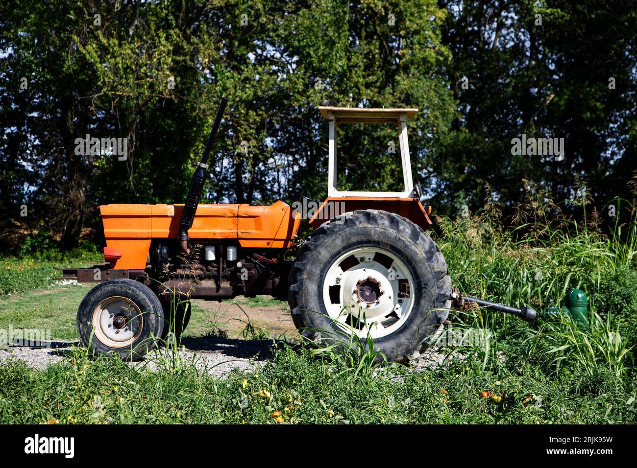 Old farm tractor abandoned in the fields Stock Photo Alamy