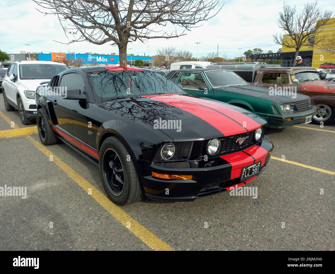 Red and black sport muscle car Ford Mustang GT coupe in a parking lot. Sunny day. CAACMACH 2023 show. Stock Photo