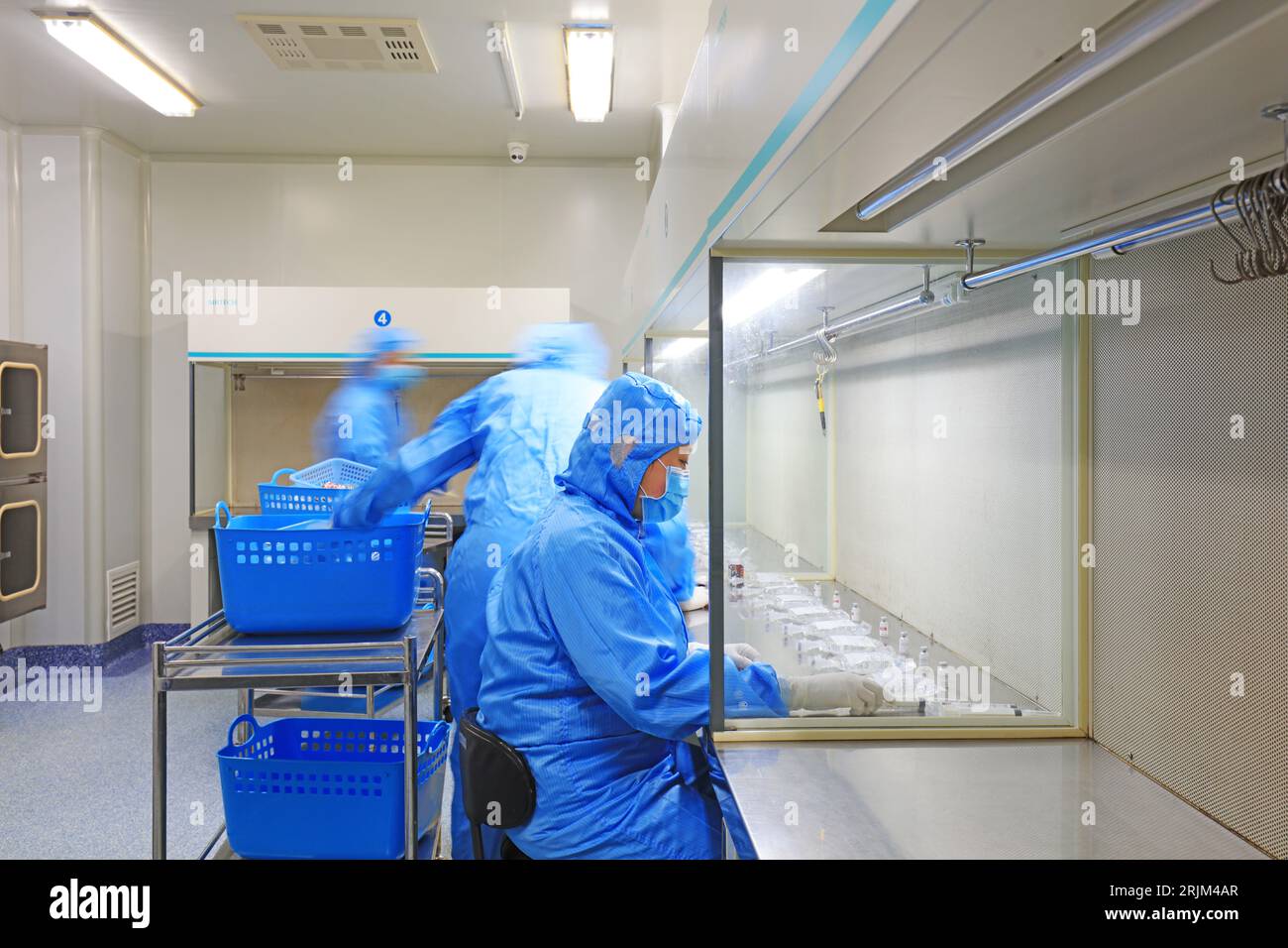 Medical workers dispense liquid in sterile room Stock Photo Alamy